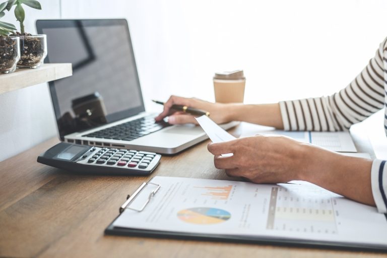 female accountant calculations audit and analyzin 2025 01 09 06 09 14 utc1 Rad na računima uz laptop, kalkulator i poslovne dokumente